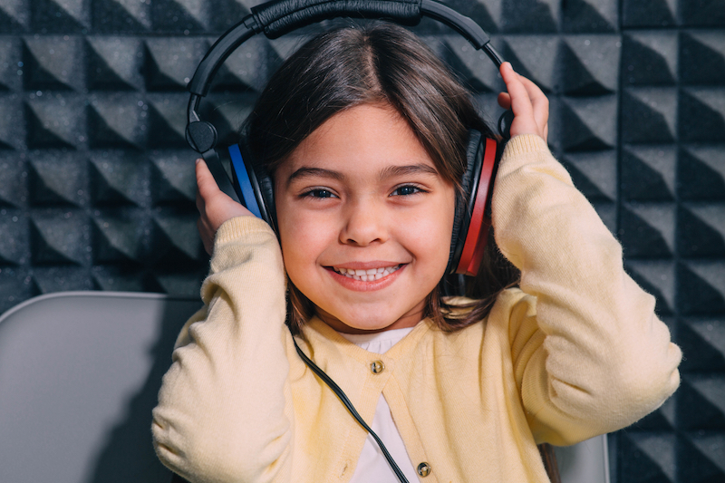 Girl wearing special headphones getting hearing test.